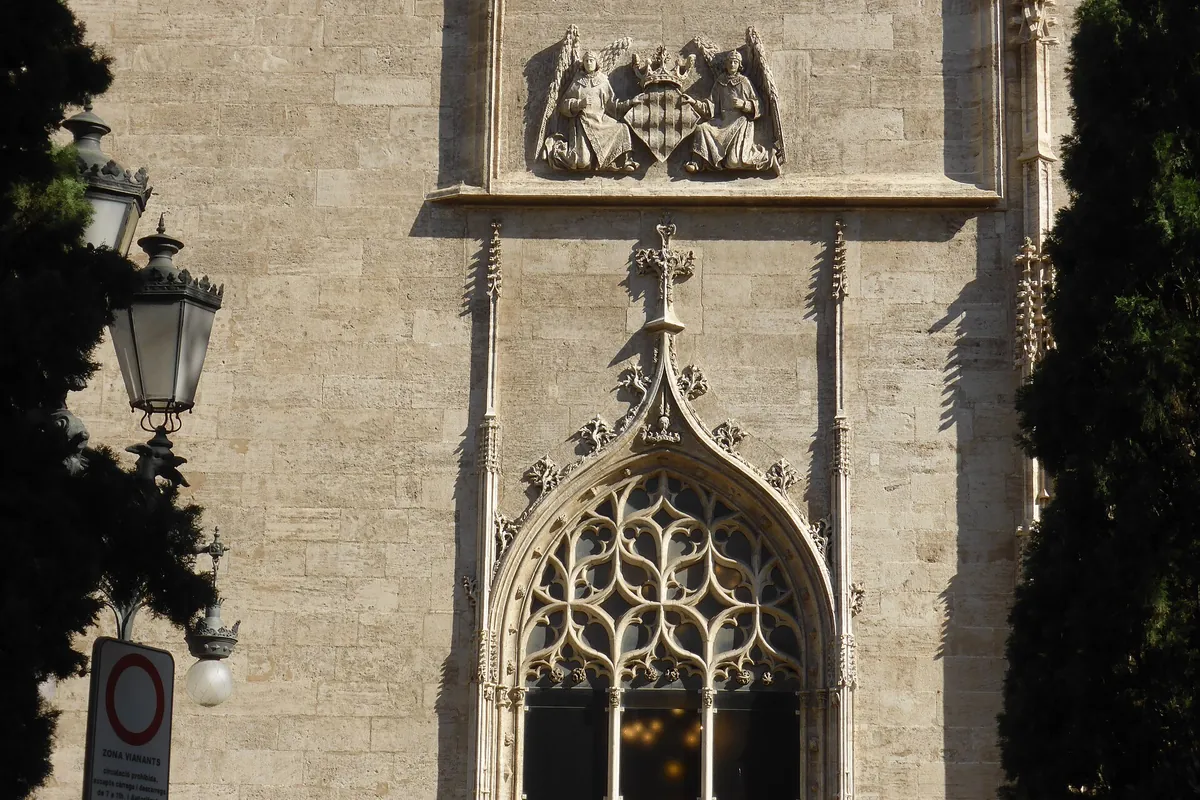 The Gothic facade of the Lonja de la Seda in Valencia, with pointed windows and battlements in warm stone
